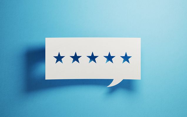 Concept image with 5 stars cut out of a paper cartoon bubble symbolising customer feedback. Photo by MicroStockHub/iStock