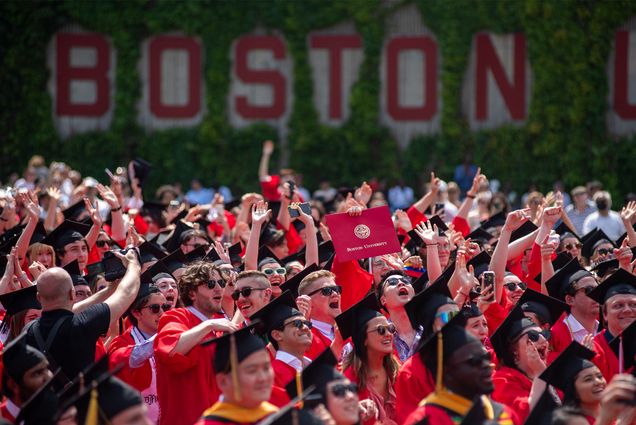 Boston University student in the sun on Nickerson Field for the 2022 Commencement activities