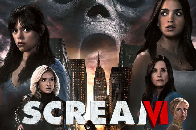 Photo: Movie poster for Scream VI movie. Various cast members looking in different directions in a V formation. Ghost face is in the middle/sky background. A cityscape is in the background, behind the test reading "Scream VI".