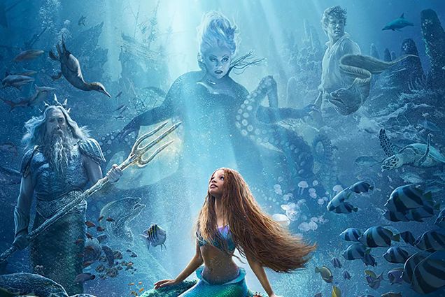 Photo: Movie poster for The Little Mermaid. Ariel with red long braids is looking up with a composite of Ursala behind her in the sea. Her father is to the left and Prince Eric is to the right.