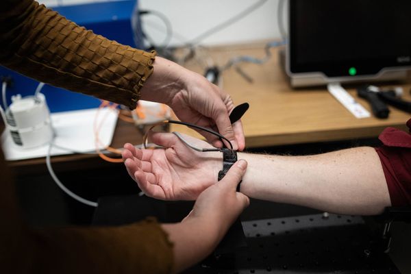 Ph.D Candidate, Ariane Garrett demonstrates how to use a cuff-less blood pressure monitor