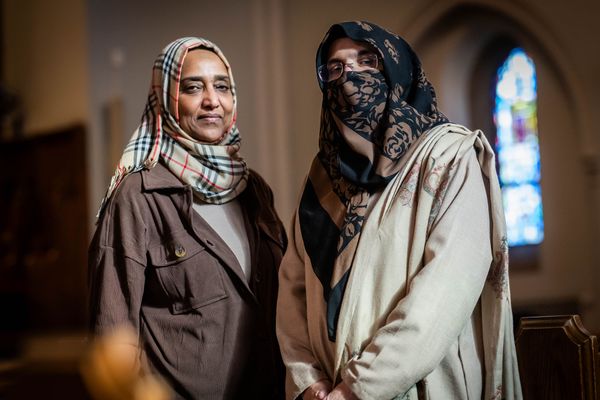 Photo: Two women in hijabs standing in a chapel