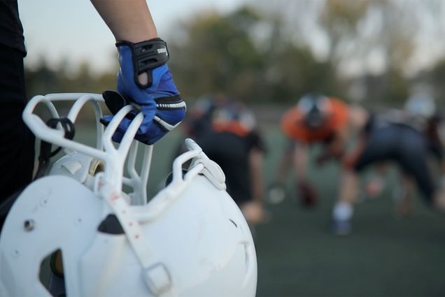 Photo: A stock image of a football player holding their football helmet.