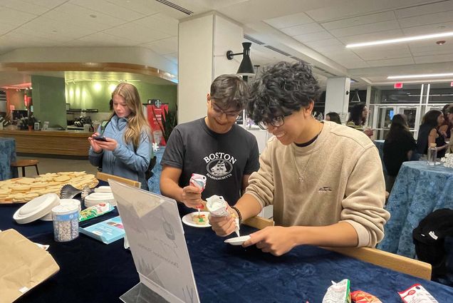 Photo: Two male students decorating cookies at Boston University's GSU