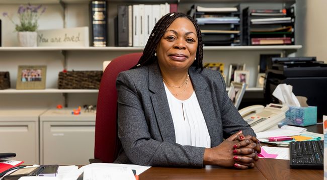 dr-lombe-sitting-at-her-desk-with-hands-folded