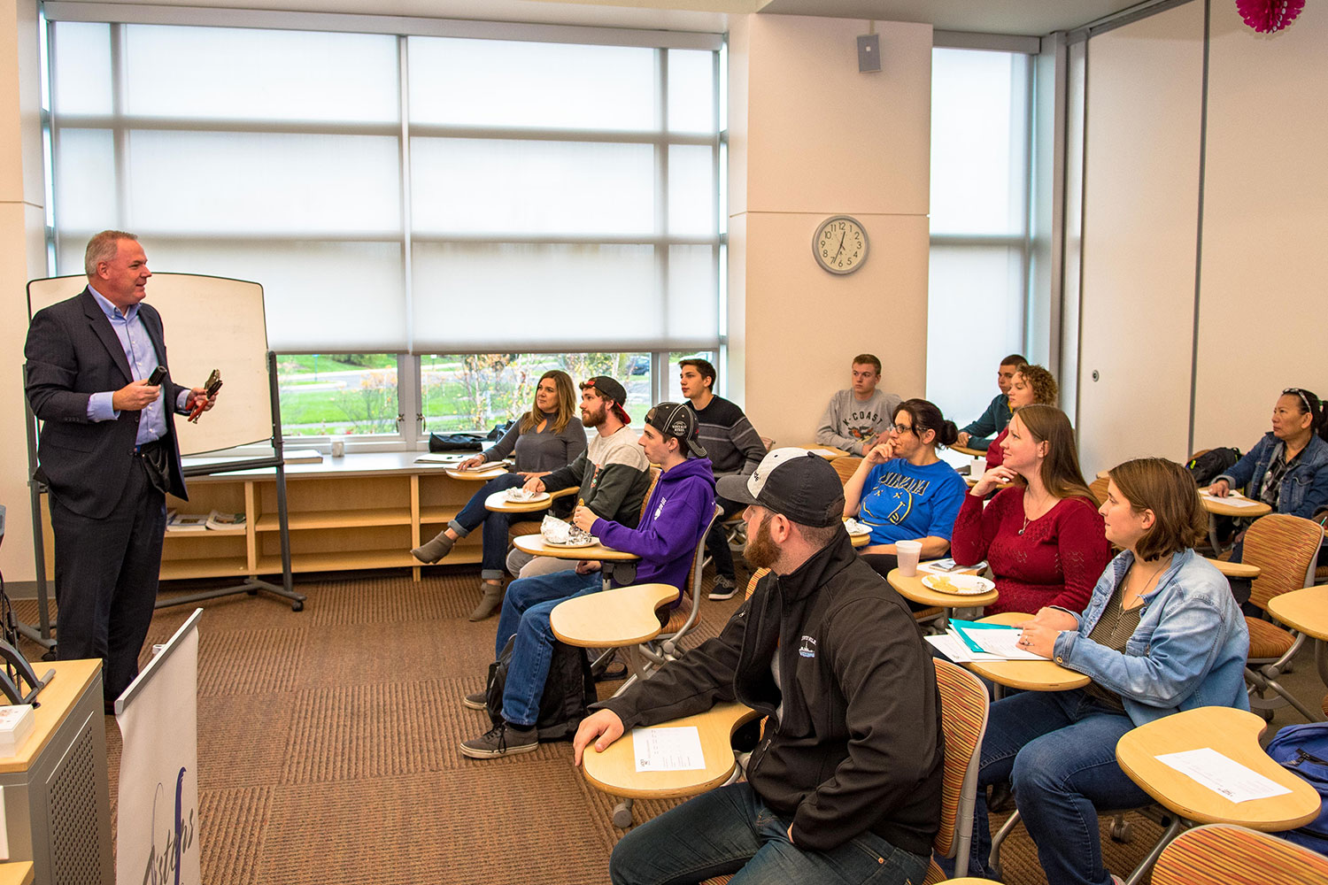 Instructor standing in front of an engaged room of students