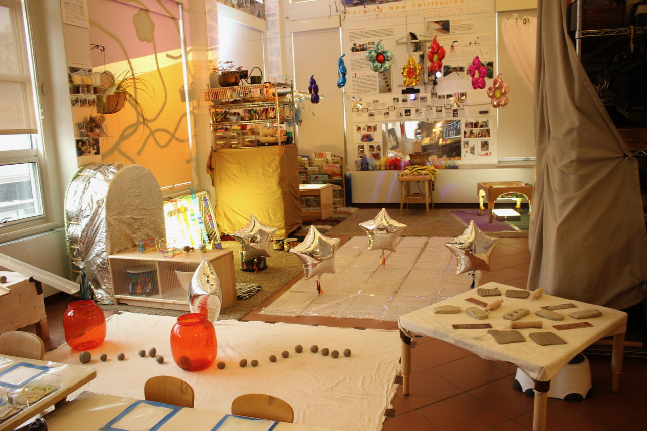 artistic space is arranged with balloons, clay, and other materials for exploration