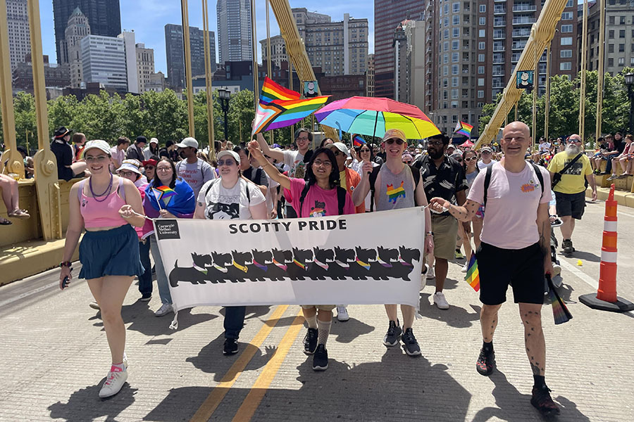 CMU participants at Pride March and Parade posing with Scotty Pride banner