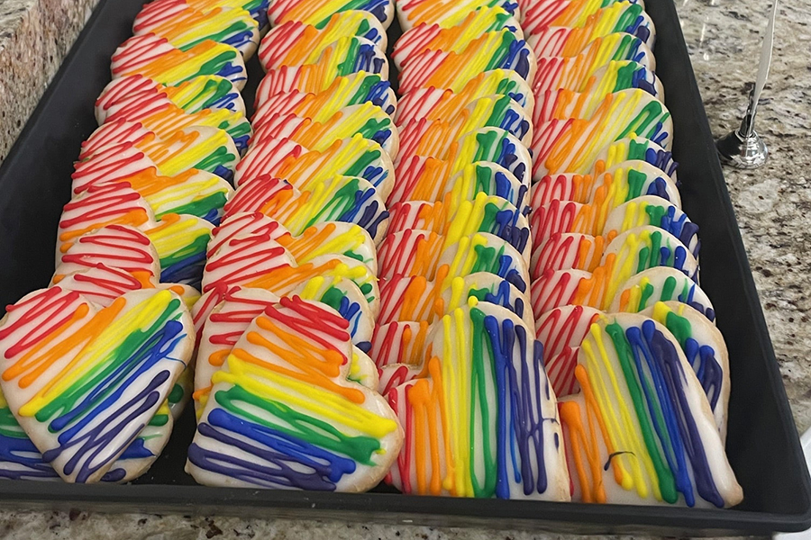 Tray of heart-shaped cookies with rainbow icing