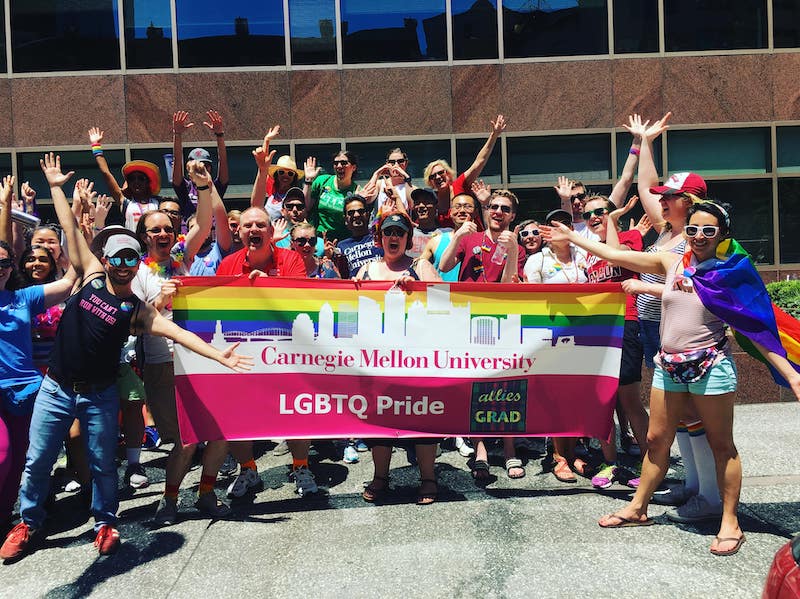 CMU students posing before PRIDE flag