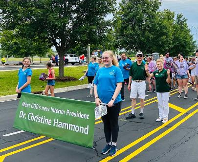 Dr. Hammond and her husband walking in a parade with others