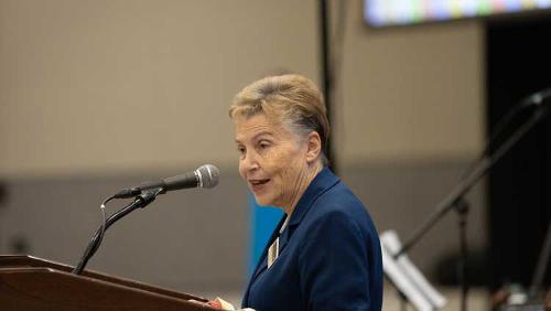 Dr. Hammond speaking in a blue suit