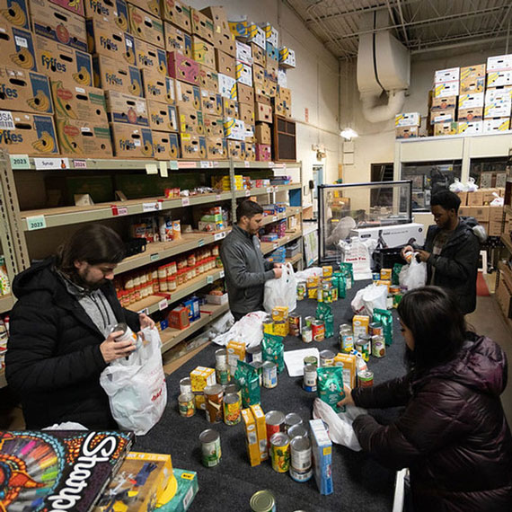 people packing bags with food