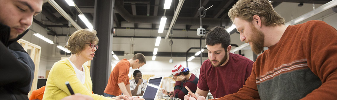 architecture students drawing at a table