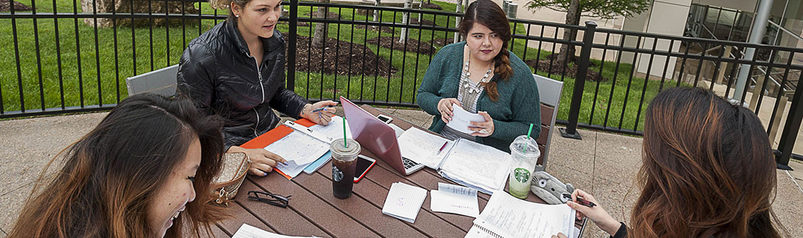 Students outside working at a table