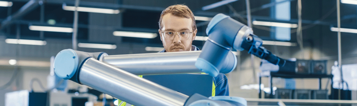 Electrical mechanical student working on a machine