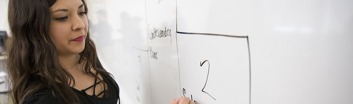 tutor writing on whiote board