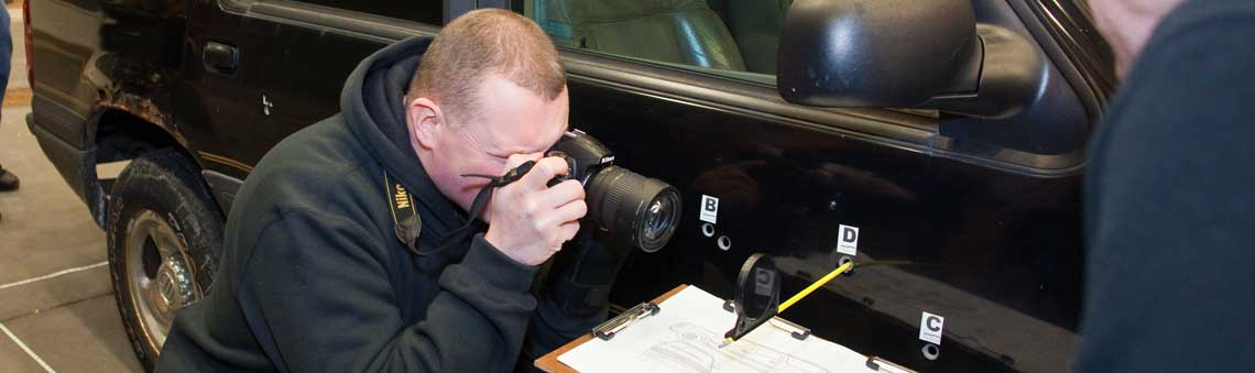 Man taking a picture of evidence for class