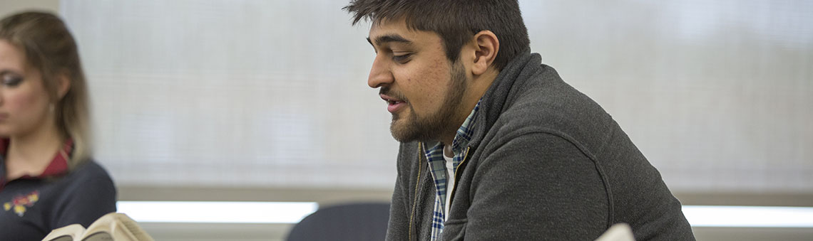 man reading from history book