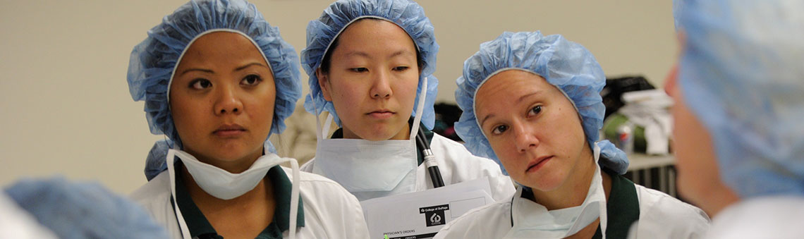 Nursing students listening to instructor lecture