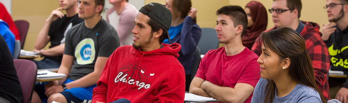 students sitting in a classroom listening to instructor