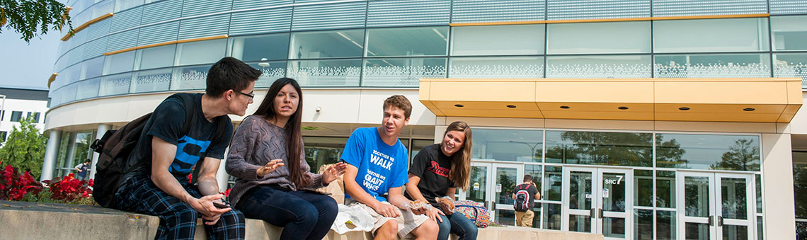 students sitting outside the student resource center