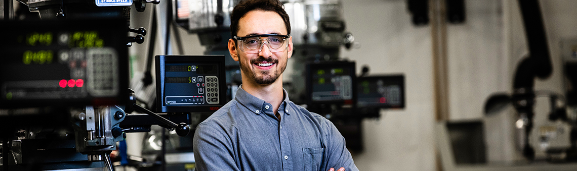 smiling man standing in manufacturing technology lab