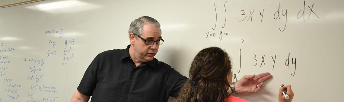 teacher helping a student with a math problem