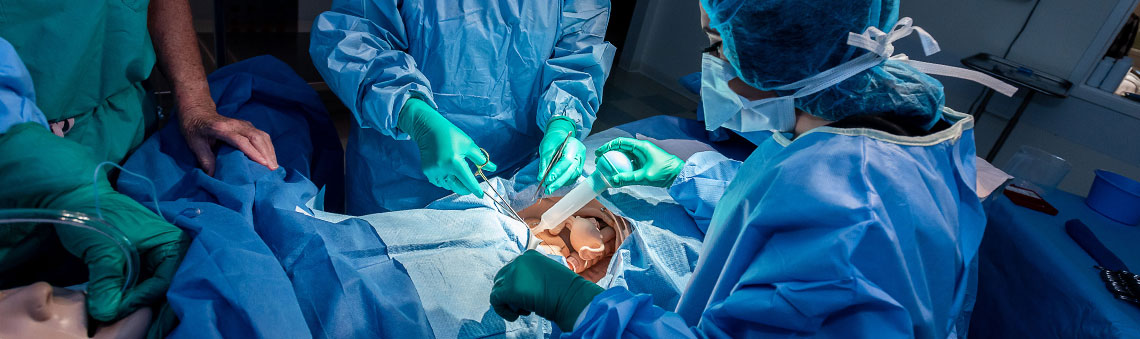 students operating on a mannequin