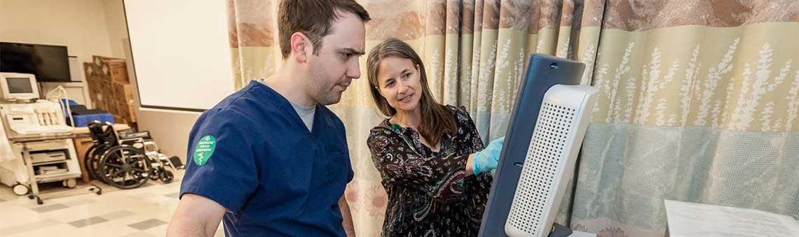 sonography student working with faculty member