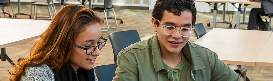 Two students working on homework at a table