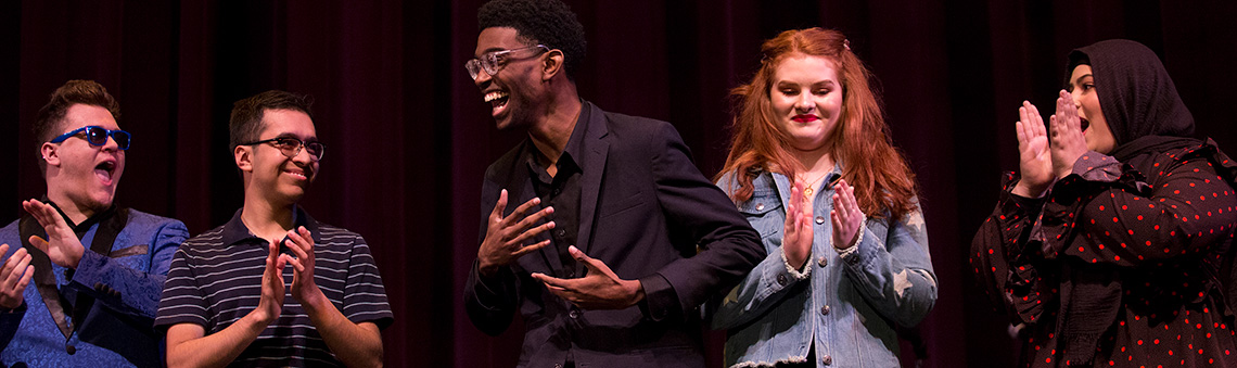 Theater students singing on stage