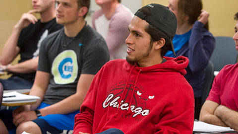 Male student sitting in classroom