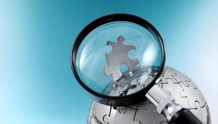 magnifying glass and puzzle piece