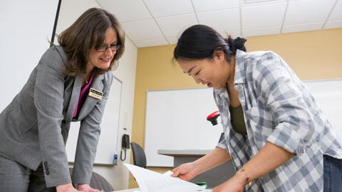 teacher working with student