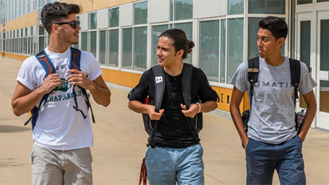 three male students walking outside