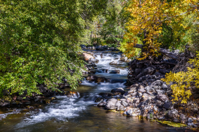 Water cascades over boulders before entering a large and deep pool at Grasshopper Point in Oak Creek Canyon.