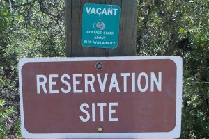 Sign says Reservation Site with green Vacant tag