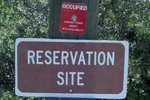 Sign says Reservation Site with red Occupied tag