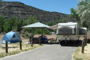 Campsite with some pavement, RVs and covered areas