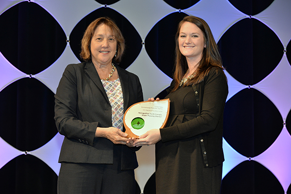 Lora Amedu accepts Excellence Award for Education and Outreach for Metropolitan North Georgia Water Planning District.