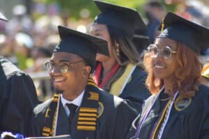 two students smiling at graduation