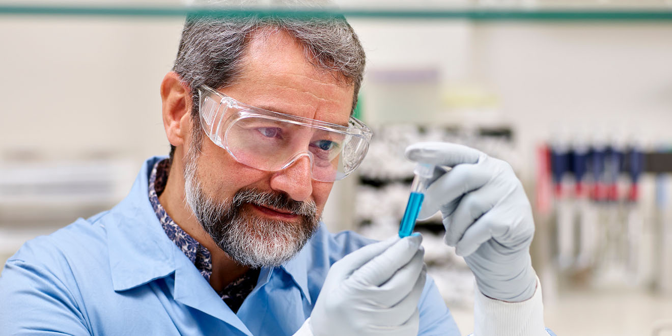 Scientist inspecting a vial