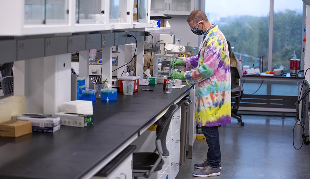 A grad student works in the Nanovaccine Institute lab