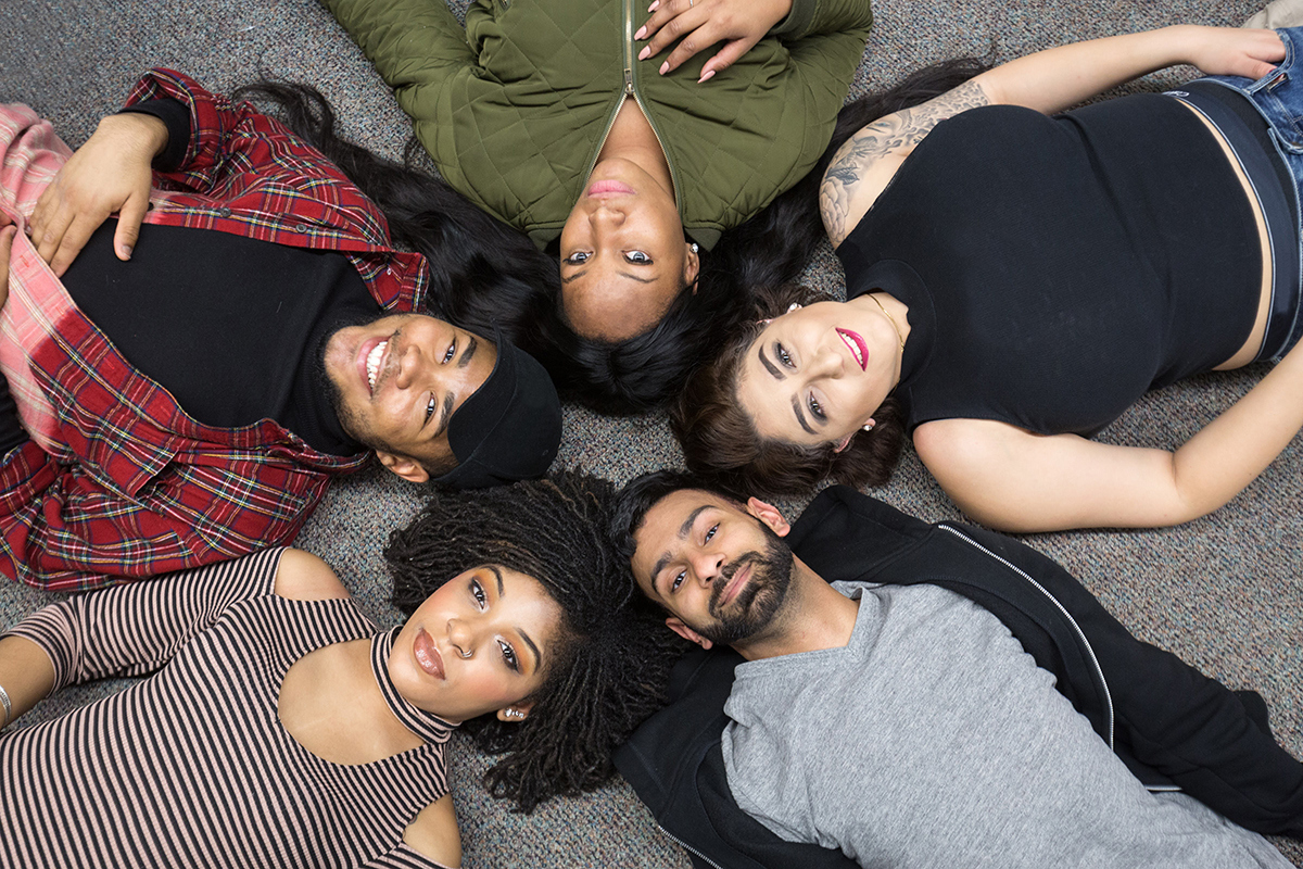 students lying on the ground in a circle