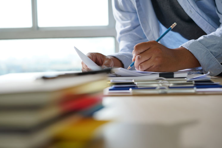 Image of person writing notes