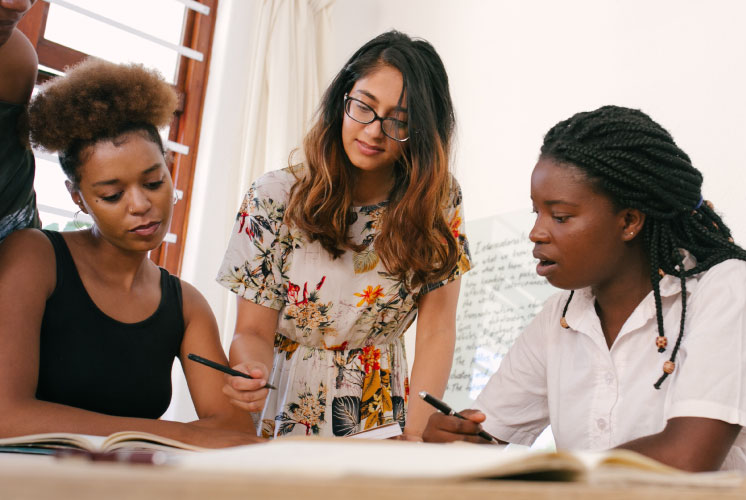 Image of women collaboratively writing.