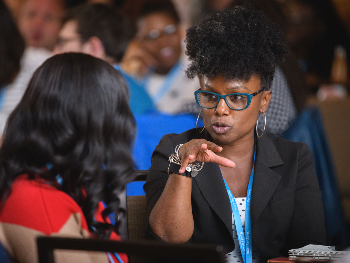 Two women at a conference in deep discussion