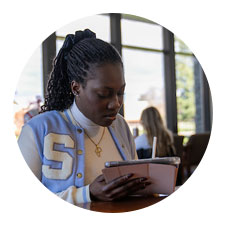 Image of a student studying in the library.