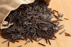 wild rice spilling from burlap bag onto counter